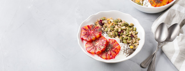 Healthy morning breakfast with granola yogurt blood oranges