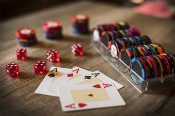 Closeup of four aces with chips and dice, gambling concept
