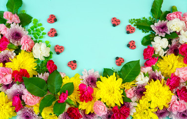 Easter springtime overhead flat lay display of fresh flowers on blue wood table background