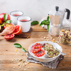 Healthy morning breakfast with granola yogurt blood oranges