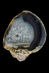 A cross-section of agate. Horizontal agate, filled with quartz. Multicolored silica rings colored...