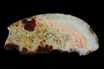 A cross-section of agate. Agate with quartz-agate fill. Multicolored silica bands colored with...