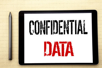 Handwritten text showing Confidential Data. Business concept writing for Secret Protection Written on tablet computer screen, white background in  office space view with pencil marker