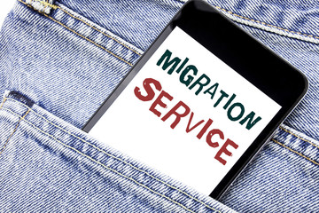 Handwriting Announcement text showing Migration Service. Business concept for Online Network Idea Written phone mobile phone, cellphone placed in the man front jeans pocket.