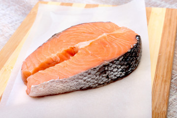 fresh raw salmon with spices on wooden cutting board. ready for cookin