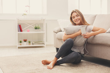 Smiling girl at home listening to music at home