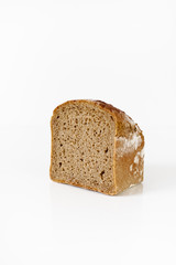 Piece of typical German wholegrain, low carb brown bread eaten for breakfast on white background