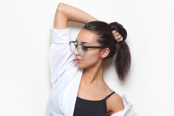 young girl in stylish glasses on a light background