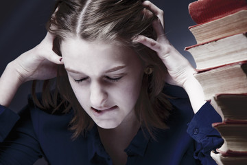  Heavy education. Young depressed female student with books feels frustration. (Science, effort,...