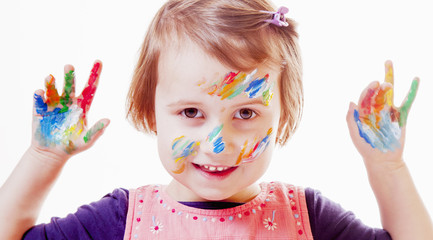 Colorful painted hands in a beautiful young girl