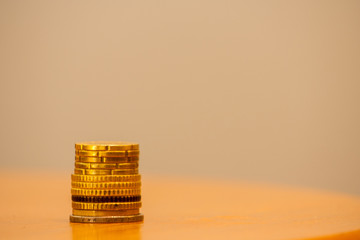 Close up of stacked euro coins on a table, bright background