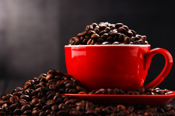 Composition with red cup of coffee and beans