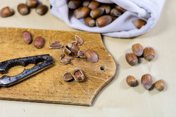 Tasty hazelnuts on a wooden kitchen table. Forest specialties and kitchen accessories.