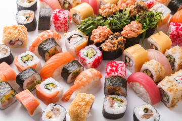 Set of sushi, maki and rolls on white