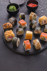 Set of sushi maki and rolls on gray background © Prostock-studio