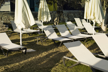 View of many sunbeds and closed umbrellas