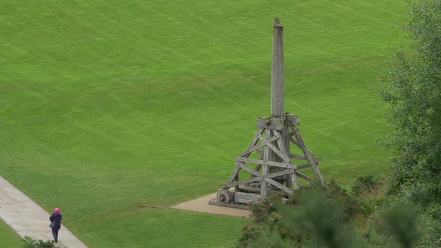 Replica of wooden trebuchet on green grass
