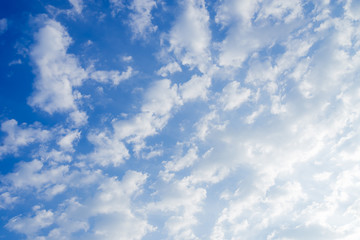 Blue skies and bright white clouds in summer to use as a background for Text or advertising.