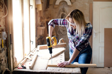 Young woman is screwing screws