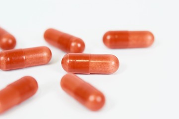 Garnets capsules on white background