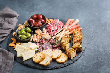 Assortment of spanish tapas or italian antipasti with meat