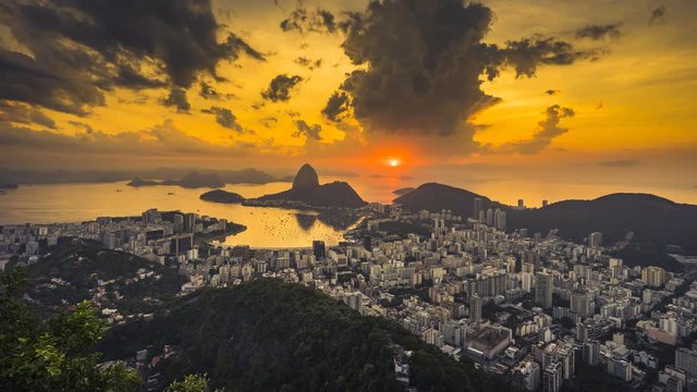 Sunrise over Sugarloaf Mountain and Botafogo Bay, Rio de Janeiro, Brazil. Reflection of the rising sun on water. Wide angle