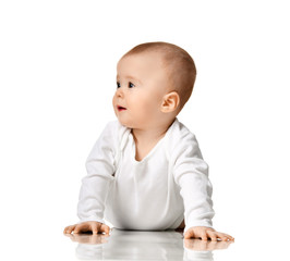 7 month infant child baby  girl toddler sitting in white shirt looking at the corner 