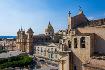 Fototapeta na wymiar View of the baroque cathedral church, symbol of the city, you can also see the 3 bells of the Santissimo Salvatore church, Noto