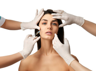 Naklejka premium Plastic surgery beauty concept young brunette woman face and doctor hand in glove with syringe