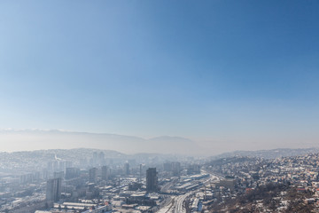 Picture of the newer part of Sarajevo (Novo Sarajevo) seen from an elevated point of view during a cold winter afternoon, snow covering the landscape