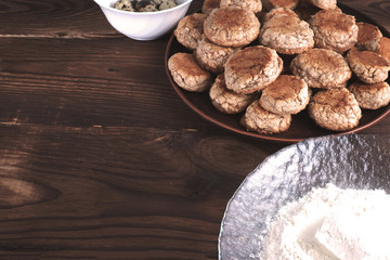 Cookies, flour and quail eggs on a wooden surface.