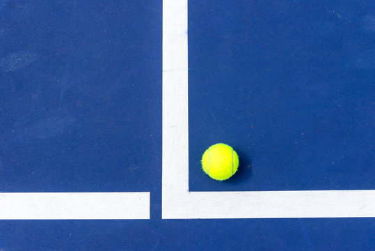 tennis ball on the corner of court