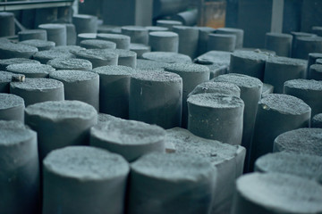 Graphite manufactured articles with unequal height standing at production department of modern...