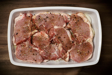 Raw meat, beef steaks on dark background, top view