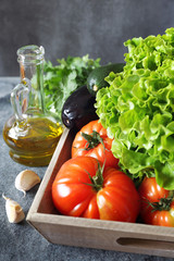 Vegetable background: lettuce, tomatoes, aubergine, zucchini and olive