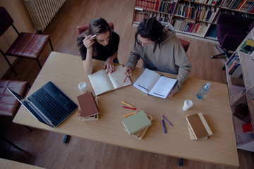 Caucasian couple learning in library