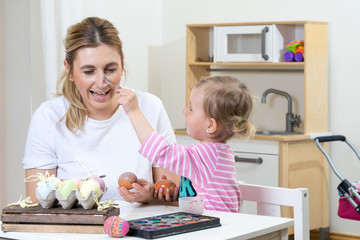 mom mum daughter have fun decorating easter egg kids room kitchen time together 