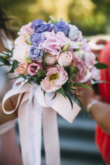bridegroom taking wedding flowers in hands