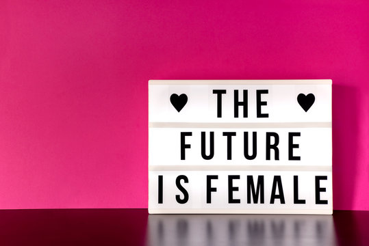 International Women's Day - concept - 'Press for Progress' 2018 theme "The Future is Female" - light box with cinema style lettering on hot pink background with copy space
