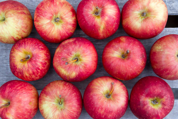 red apples on rustic wooden background