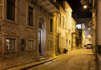 Fototapeta na wymiar Night view of historical, old street in old town of Ayvalik. Sto