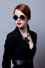 Portriat of style redhead girl in black clothes