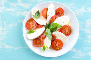Italian style salad with mozzarella cheese tomato basil summer light olive oil