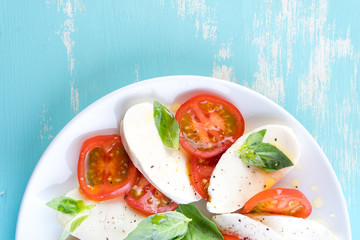 Italian style salad with mozzarella cheese tomato basil summer light olive oil