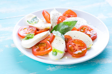 Italian style salad with mozzarella cheese tomato basil summer light olive oil