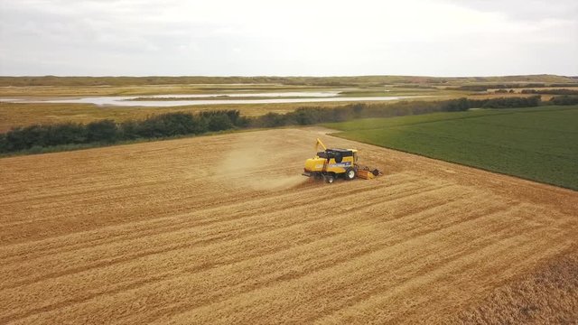An aerial of a machine harvesting in the countryside of Zeeland, the Netherlands