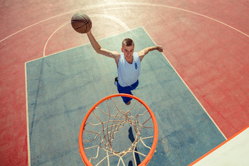 High angle view of basketball player dunking basketball in hoop