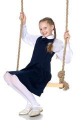 Little girl swinging on a swing