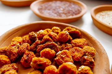 Macro closeup of dried Peruvian goldenberries in a ceramic dish
