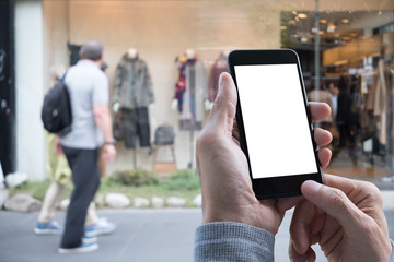 Fototapeta na wymiar Man hand holding smart phone with shopping center background